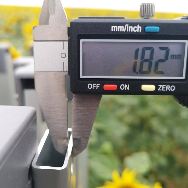 Meting van de profieldikte: Technisch detail met een schuifmaat die het massieve profiel bevestigt, waardoor deze aluminium tent een van de meest stabiele op de markt is.