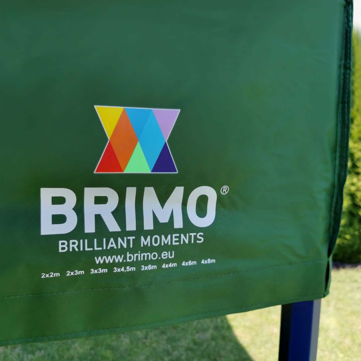 Detail van de groene stof (dak/zijkanten) van de tent met het witte logo "BRIMO" en gekleurde driehoeken.